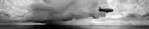 Palm Beach, Florida, USA - September 27, 2011: The Goodyear Blimp makes its way across the Atlantic shore just after sunrise as a thunderstorm builds on the horizon. Shot was taken from the 20th floor of a building to capture the eye-level view of the Blimp.